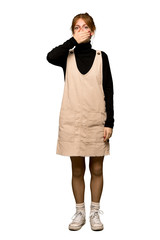 Fototapeta premium A full-length shot of a Young redhead woman covering mouth with hands for saying something inappropriate over isolated white background