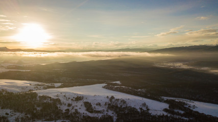 Sunset in the winter mountains landscape. Aerial view from above.