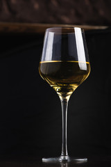 Fototapeta premium Glass of White Wine on Black Background