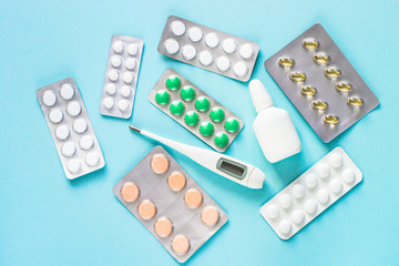 Pills on blue background top view. 