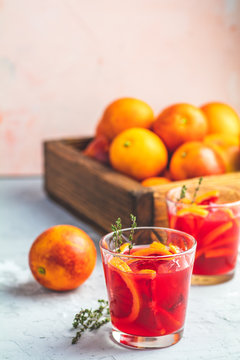 Blood orange margarita cocktail with ice and thyme