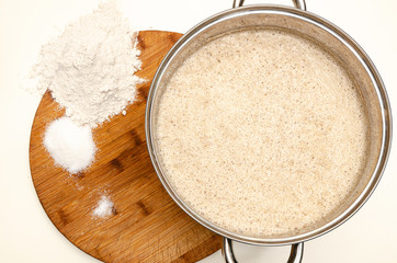 Dough in a metal pan on the table