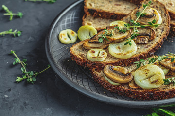 Sliced bread with fried cutting mushroom champignon and onion.