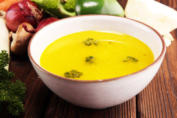 Broth with carrots, onions various fresh vegetables in a pot - colorful fresh clear spring soup. Rural kitchen scenery vegetarian bouillon or stock
