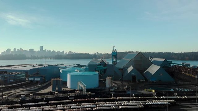 Aerial footage of the North Vancouver trainyard and cargo terminal with a view of Downtown Vancouver.