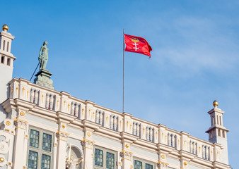 Gdansk, Poland, city flag, sign of Gdansk, on top of old building - Artus Court.