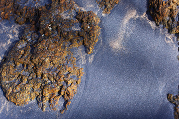 Black and white sand on the tropical beach of Sri Lanka