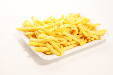 Tasty french fries on table background