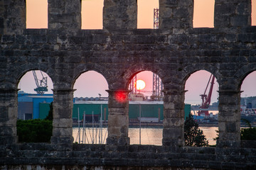 Puesta de sol vista a través anfiteatro romano en Pula, Croacia.