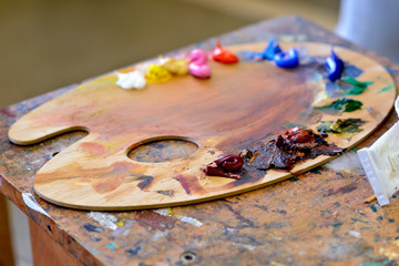 Palette with oil paints. Close up of different color oil paint.