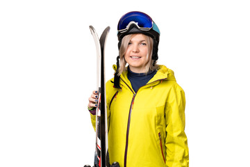 Smiling girl in helmet holding skis