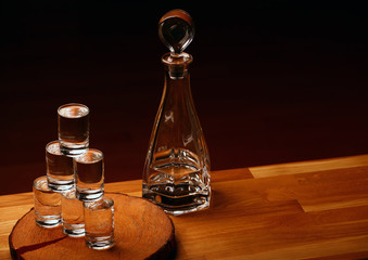 Obraz na płótnie Canvas vodka glass pyramid wooden background