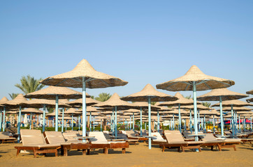 Many beach umbrella from wicker and lounge Hurgada, Egypt