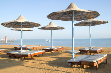 Many beach umbrella from wicker and lounge Hurgada, Egypt