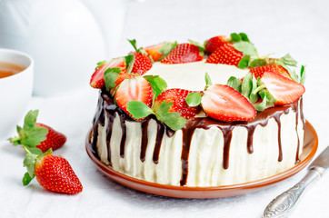 Sponge cake with cream, chocolate and strawberry