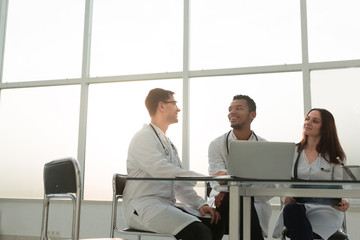 employees of the medical center sitting at his Desk .