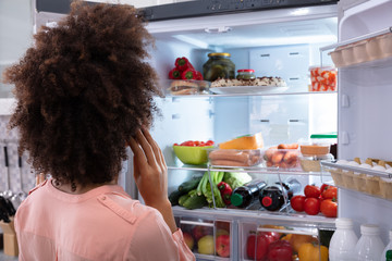 Woman Searching For Food In Refrigerator