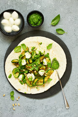 Grilled zucchini, mozzarella and pesto salad on a tortilla cake. Snack. Selective focus.