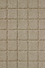 Beige color exterior wall abstract background with conglomerate look square stone brick tiles