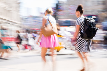 London, UK.  Beautiful motion blur of two woman, walking in the Regent street in summer day. Busy life of the capital.