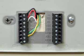 Close-up of thermostat wiring on wall