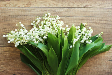 Spring bouquet of lilies of the valley, Lily of the valley on a wooden background.