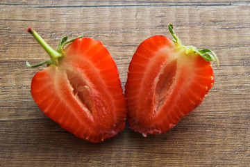 Strawberries on a wooden background, Strawberries are cut into two parts.