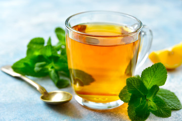 Mint tea with lemon in a glass cup.