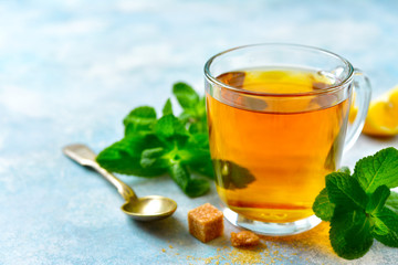 Mint tea with lemon in a glass cup.