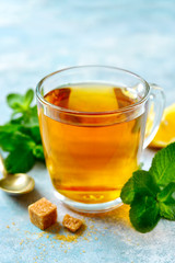 Mint tea with lemon in a glass cup.