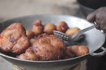 fresh donuts in big bowl: cooking in Africa close up