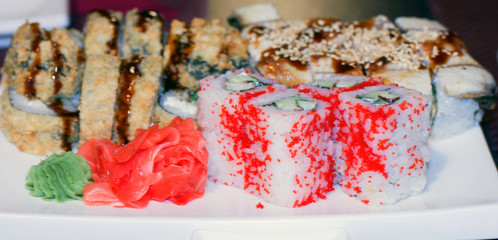 Sushi and rolls fried and with red caviar on a dish in an Asian restaurant