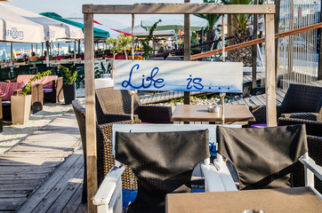 Leptokarya, Greece - June 10, 2018: Chairs in the garden restaurant in Leptokaria, Greece 