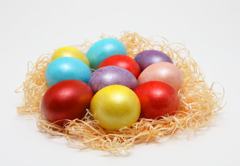 Fototapeta na wymiar Colorful Easter eggs in a nest on white background, Spring Image. Easter concept.