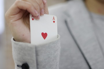 Concept image of a person hiding an ace up their sleeve.