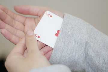 Concept image of a person hiding an ace up their sleeve.