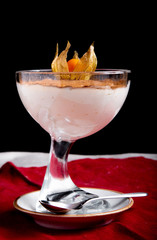 Traditional Italian dessert tiramisu in glass on light Black background.