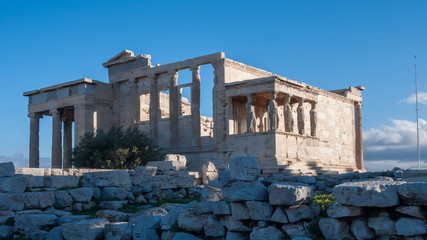 Fototapeta na wymiar Ruins of The Porch of the Caryatids in The Erechtheion an ancient Greek temple at Acropolis of Athens, Attica, Greece