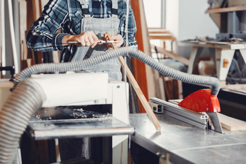 The carpenter works with a tree