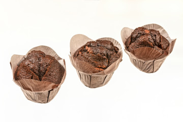 three chocolate muffin cupcake isolated on white background