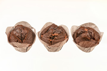 three chocolate muffin cupcake isolated on white background