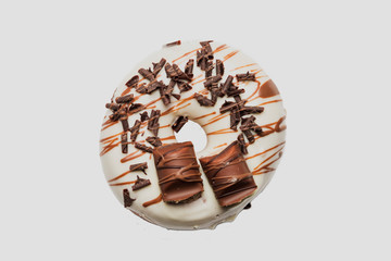 White chocolate glazed donut and chocolate topping on white background. High resolution image for food industry.