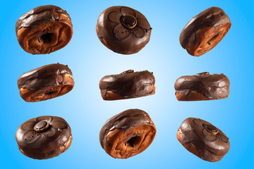 Chocolate glazed doghnut with chocolate cookie in middle on blue background. High resolution image for food industry.