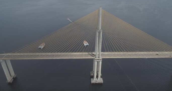 High aerial above the cable-stayed Rio Negro Bridge that links the cities of Manaus and Iranduba in the Brazilian Amazon as a traffic crosses from one side to another