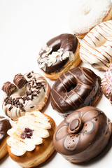 Multiple doughnuts on white background. High resolution image for food industry.