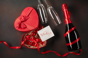 Valentine's Day with a box of chocolates in the form of a heart with a bottle of champagne with...