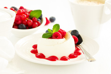 Delicious Italian dessert panna cotta with berries and berry sauce. Valentine's Day.