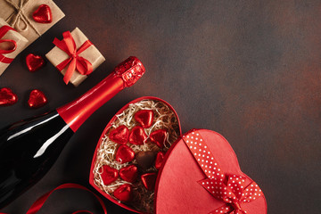 Valentine's Day with a box of chocolates in the form of heart gifts and champagne. Top view with...