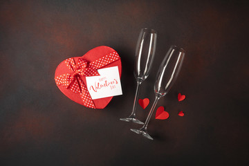 Valentine's Day with glasses box of chocolates in the form of a heart and a note. Top view with...