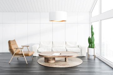 White attic living room, sofa and armchair